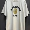 A BATHING APE-BAPE Gold with Monogram Head Logo Tee
